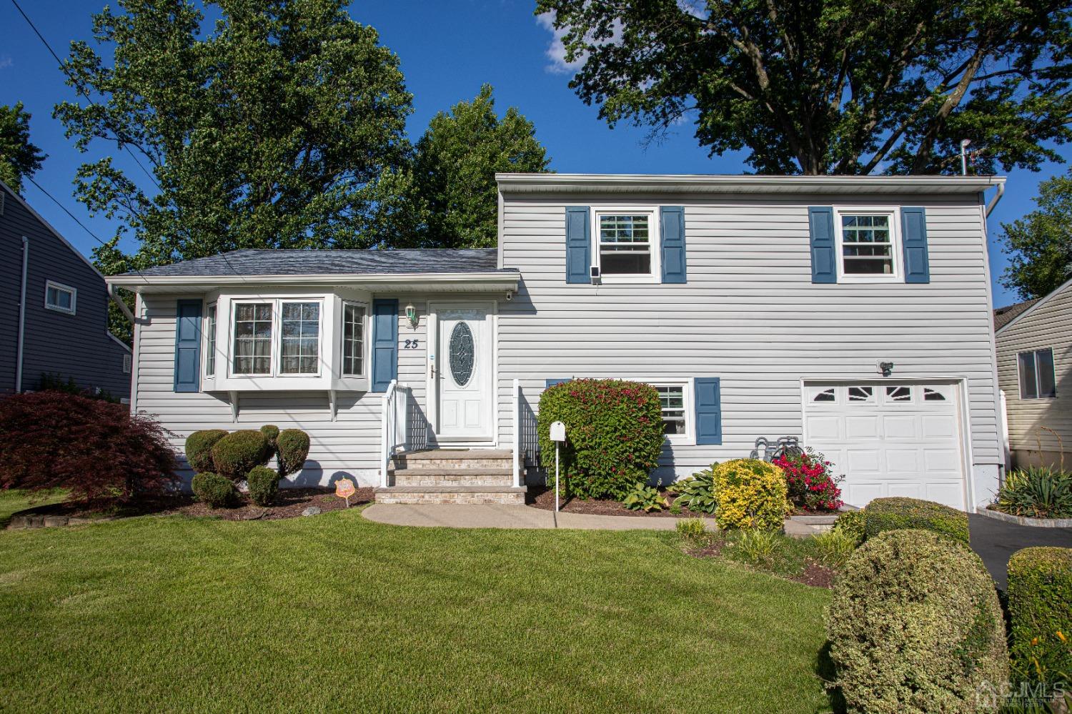 25 Finley Road Edison, NJ 08817 - Photo 1 of 51 a front view of a house with garden