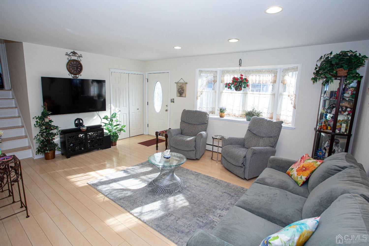 25 Finley Road Edison, NJ 08817 - Photo 2 of 51 a living room with furniture and a flat screen tv