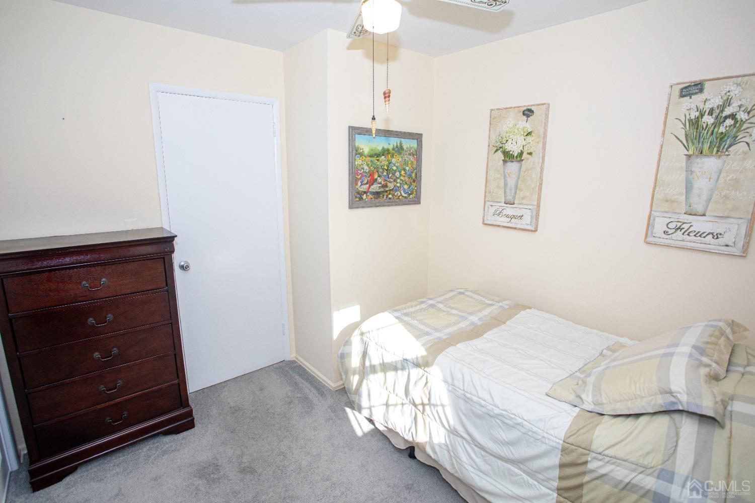 25 Finley Road Edison, NJ 08817 - Photo 31 of 51 a bedroom with a bed and a dresser