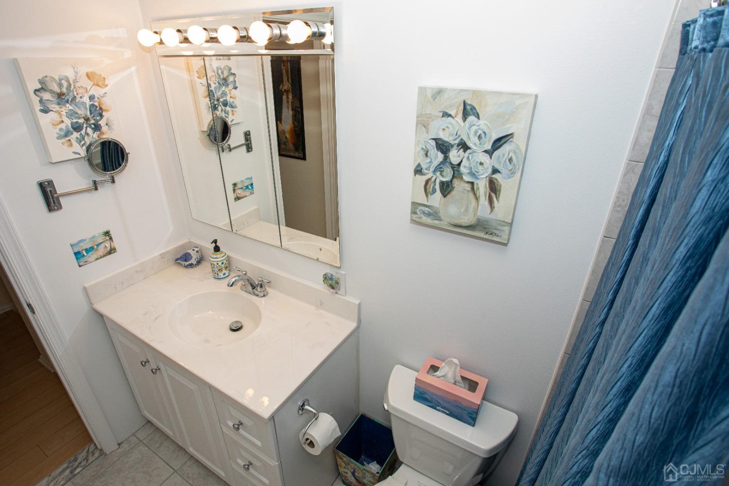 25 Finley Road Edison, NJ 08817 - Photo 34 of 51 a bathroom with a sink mirror and vanity