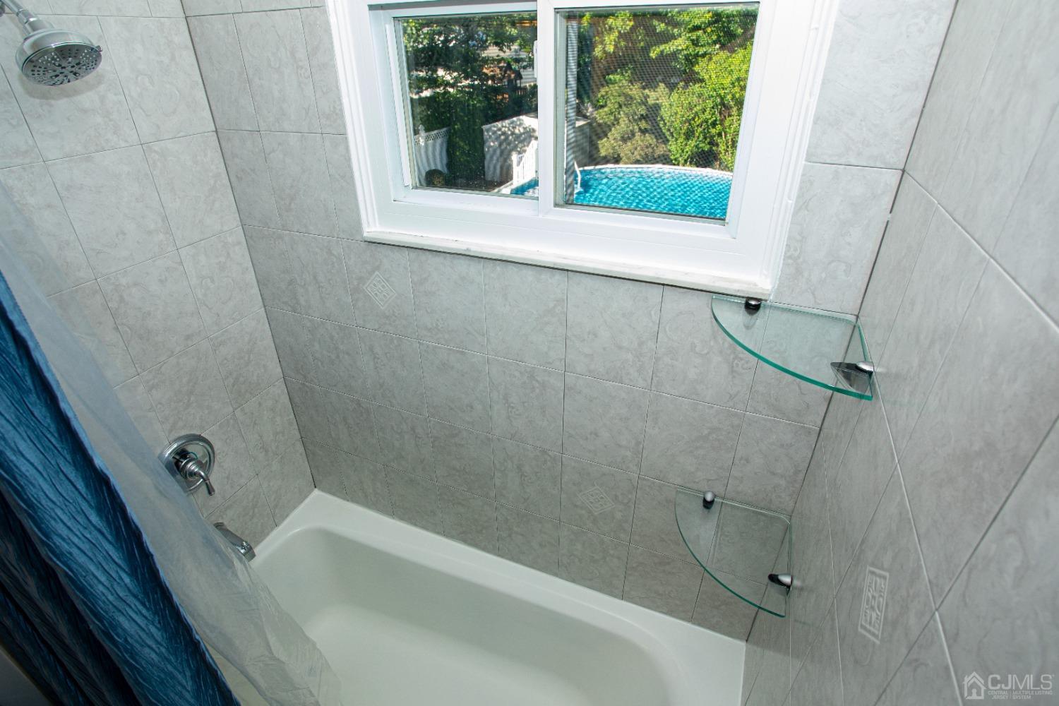 25 Finley Road Edison, NJ 08817 - Photo 35 of 51 a bathroom with a tub and shower