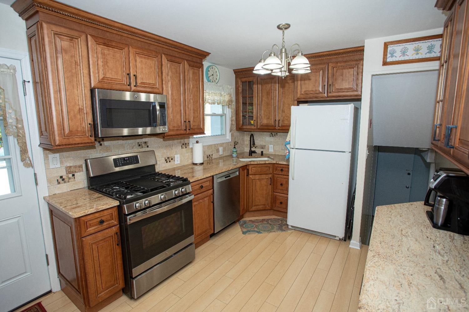 25 Finley Road Edison, NJ 08817 - Photo 4 of 51 a kitchen with a sink stove and refrigerator