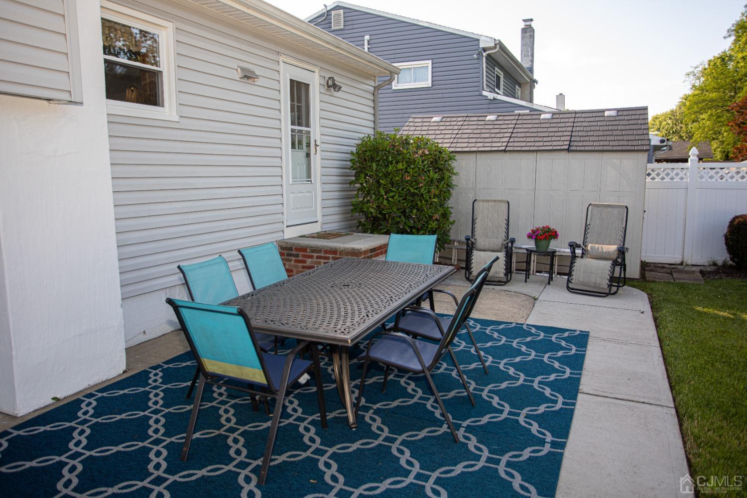 25 Finley Road Edison, NJ 08817 - Photo 6 of 51 a backyard of a house with table and chairs