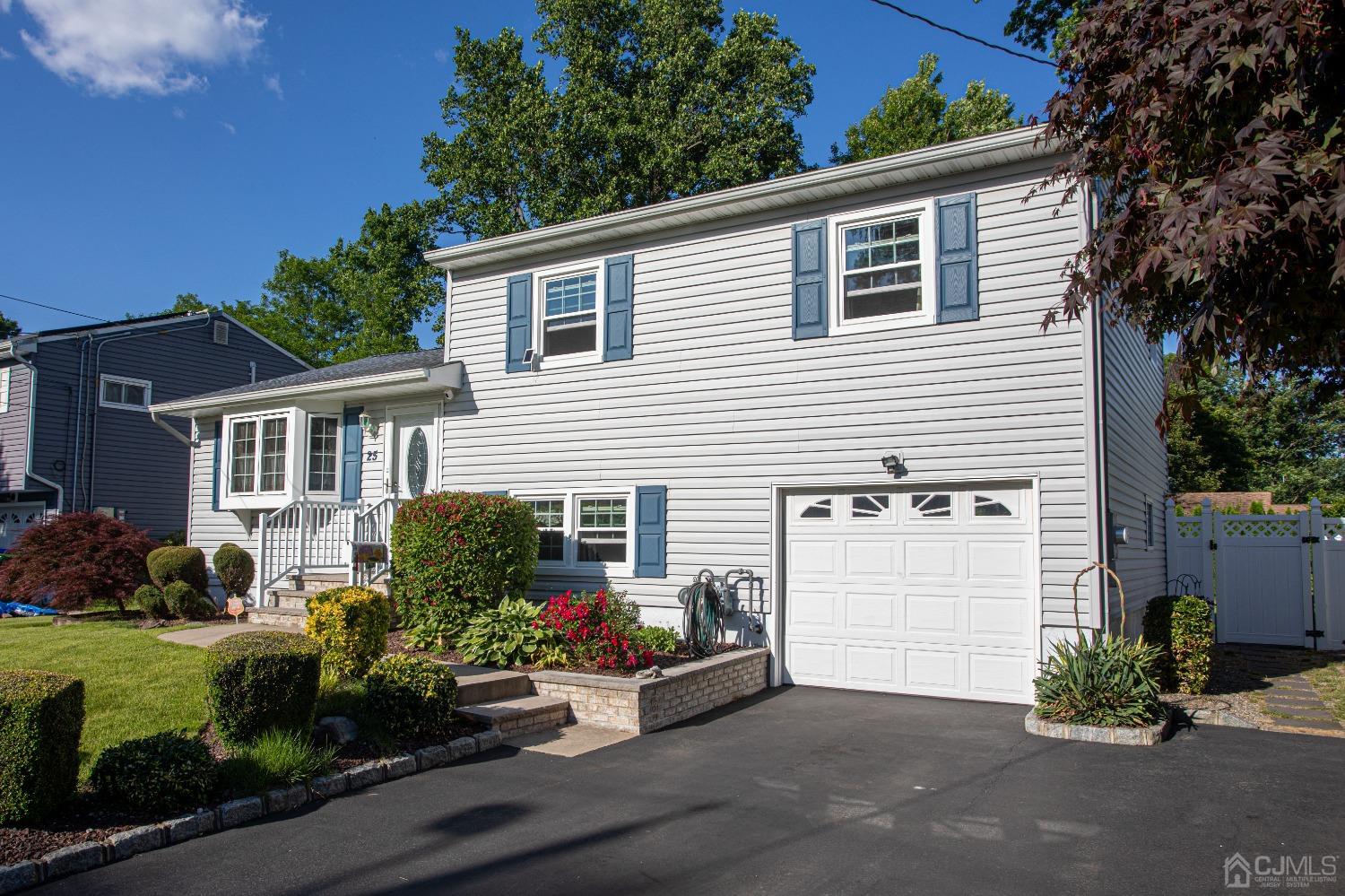 25 Finley Road Edison, NJ 08817 - Photo 9 of 51 a view of a house with a yard and a garden