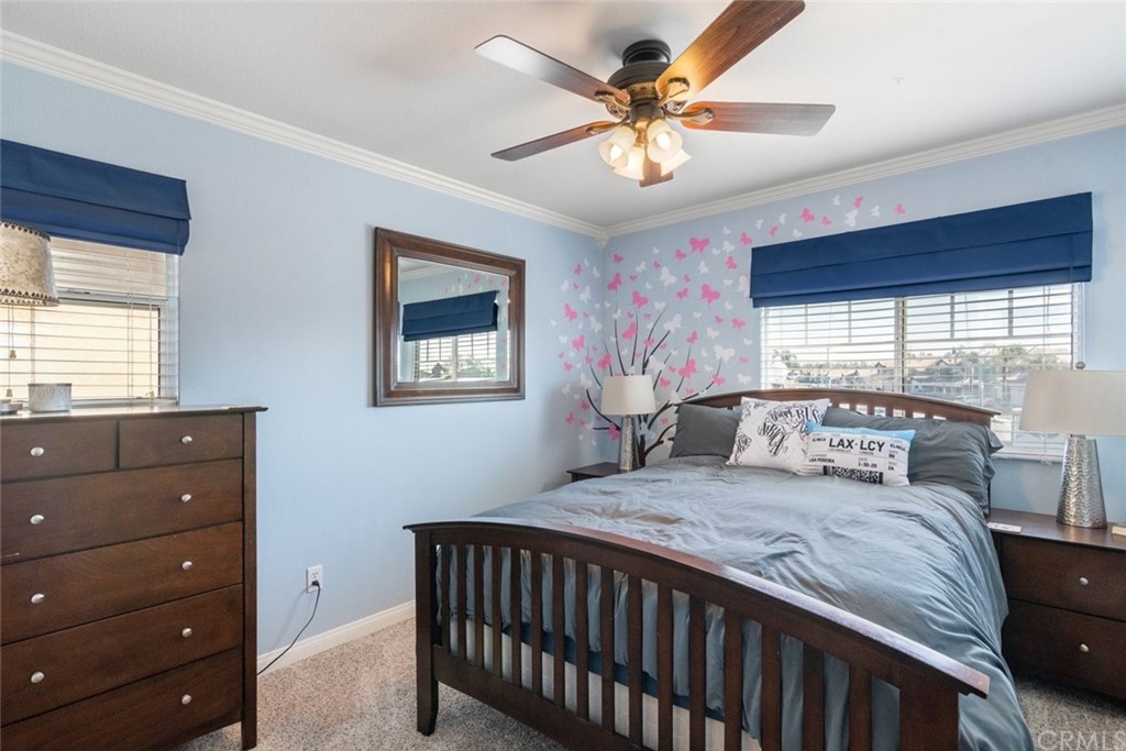 5624 Pheasant Drive Fontana, CA 92336 - Photo 12 of 20 a bedroom with a bed a window and a chandelier