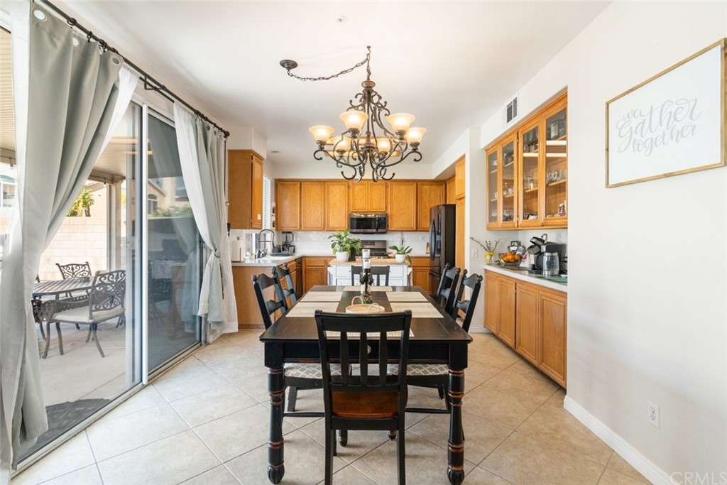 5624 Pheasant Drive Fontana, CA 92336 - Photo 6 of 20 a view of a dining room with furniture wooden floor and chandelier