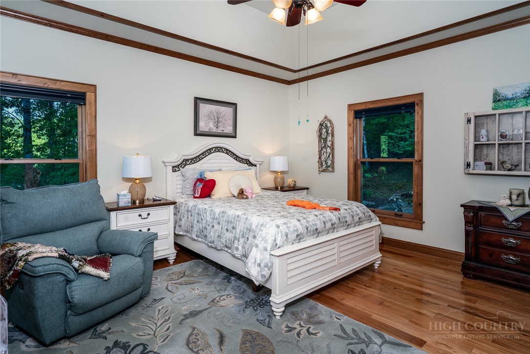 171 Camp Davis Road Banner Elk, NC 28604 - Photo 23 of 48 a bedroom with a bed and wooden floor
