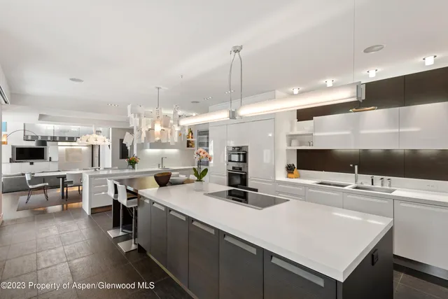 a kitchen with lots of counter top space and painting on the wall