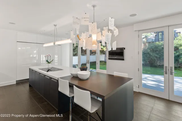 a kitchen with stainless steel appliances granite countertop a sink a stove and a refrigerator