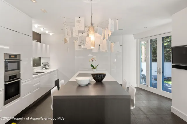 a view of kitchen with stainless steel appliances kitchen island sink stove and refrigerator