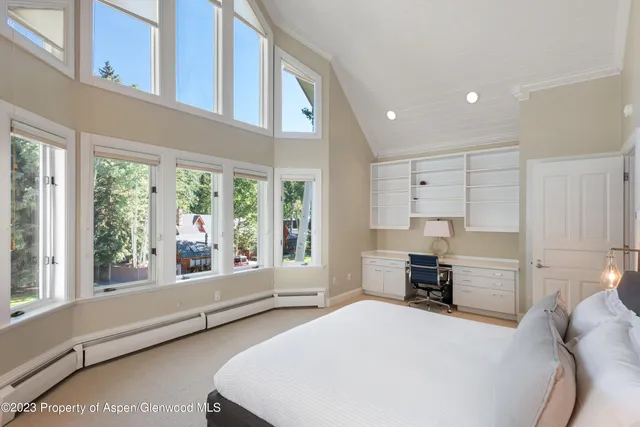 a bedroom with a large bed and a large window