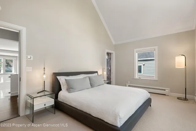 a bedroom with a bed and a night stand