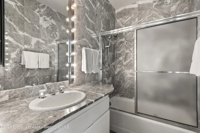 a bathroom with a sink and shower