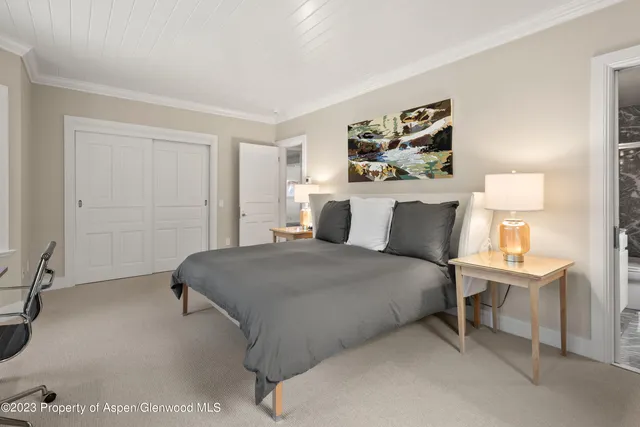 a bedroom with a bed and lamp