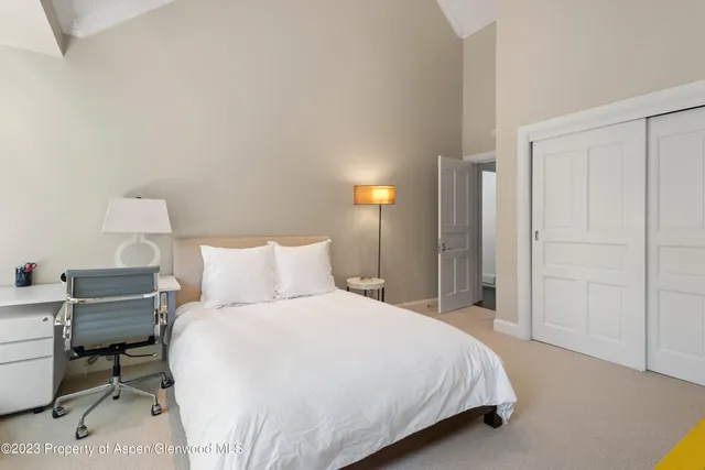 a bedroom with a bed and a table in it