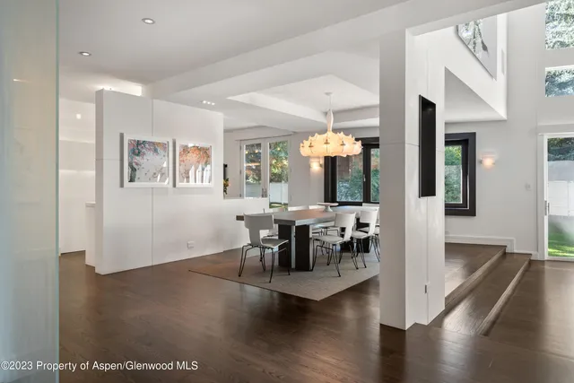 a view of a dining room with furniture and wooden floor