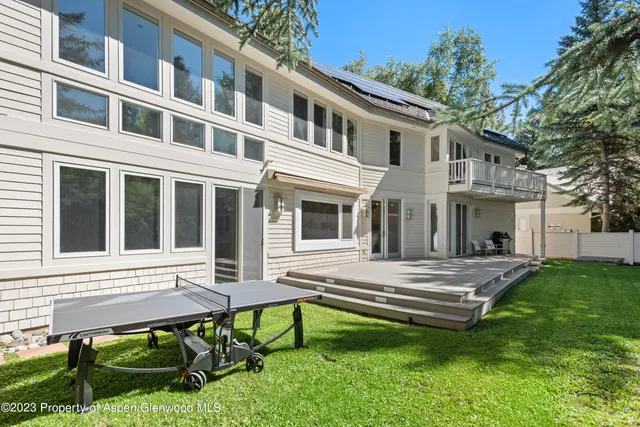a view of a house with backyard porch and sitting area