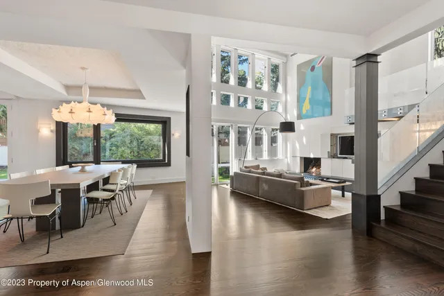 a living room with fireplace furniture and a large window