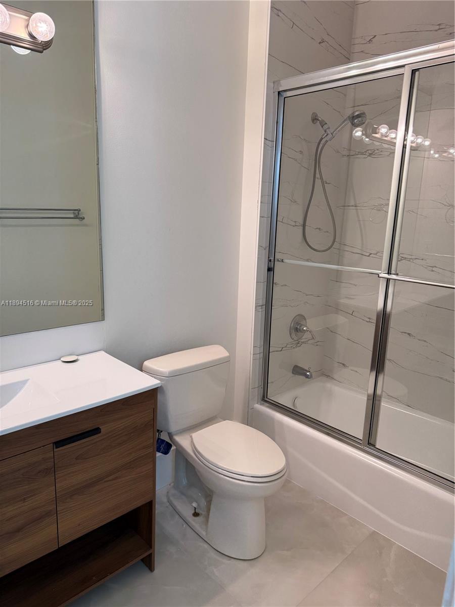 2273 Phoenix Avenue Davie, FL 33324 - Photo 11 of 20 a bathroom with a granite countertop toilet a sink and shower