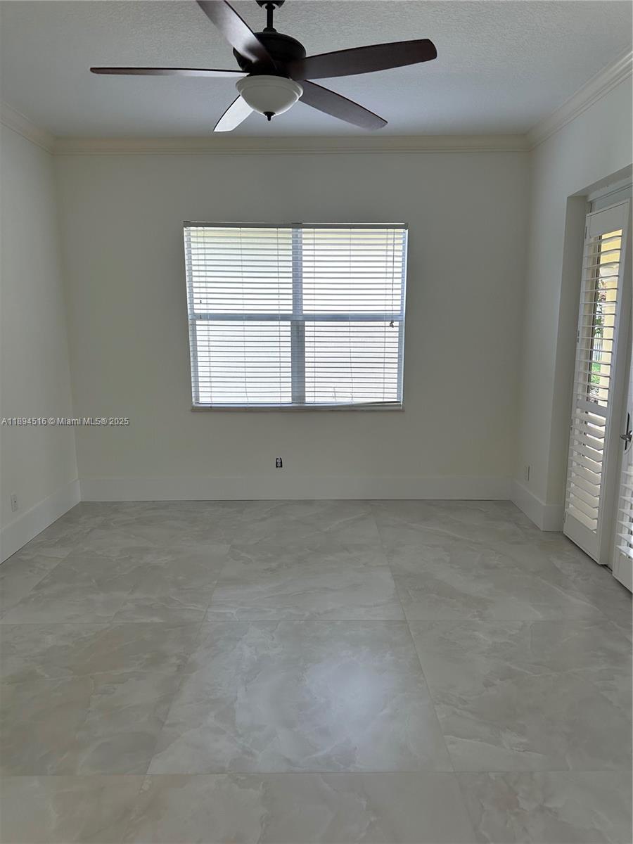 2273 Phoenix Avenue Davie, FL 33324 - Photo 13 of 20 an empty room with a ceiling fan and windows