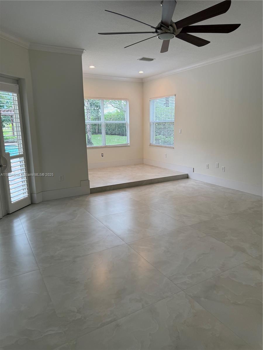 2273 Phoenix Avenue Davie, FL 33324 - Photo 16 of 20 an empty room with wooden floor fan and windows