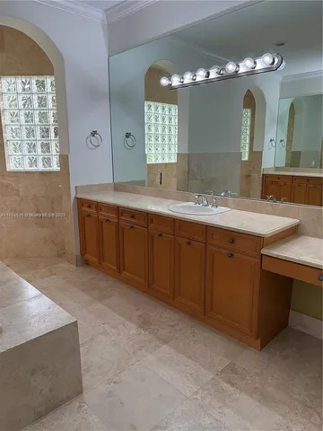 a spacious bathroom with a granite countertop double vanity sink and a mirror