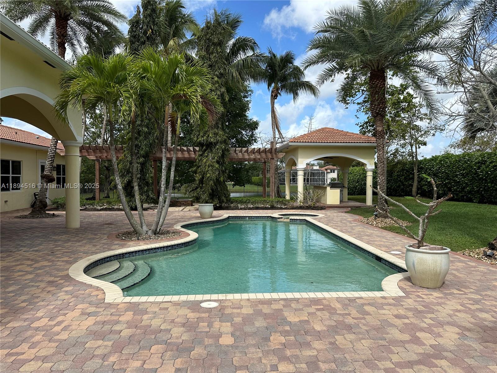 2273 Phoenix Avenue Davie, FL 33324 - Photo 3 of 20 a view of a swimming pool with a patio