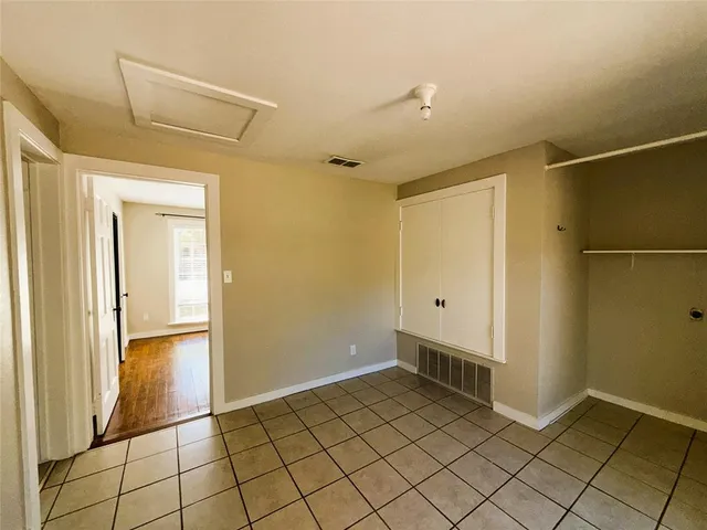 a view of a livingroom with wooden floor and a window