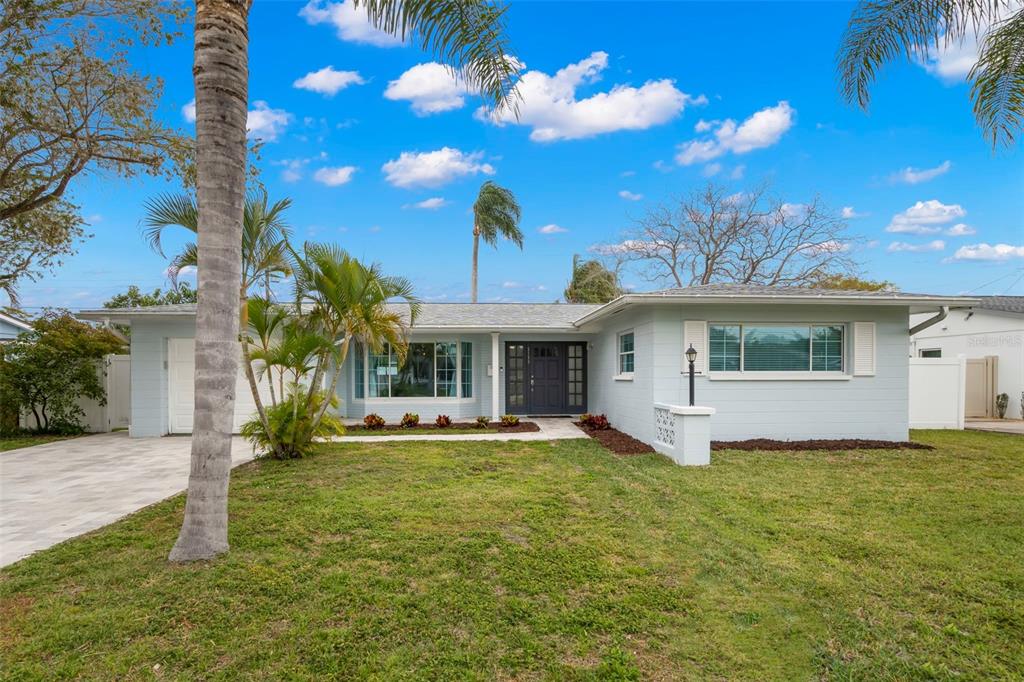 3159 61st Lane North St. Petersburg, FL 33710 - Photo 1 of 1 a front view of a house with a yard and garage