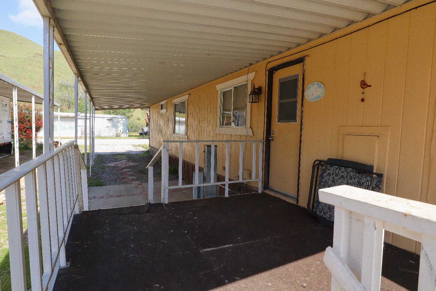 25433 East Trimmer Springs Road, Unit 4 Sanger, CA 93657 - Photo 16 of 33 a view of a porch with wooden floor and fence