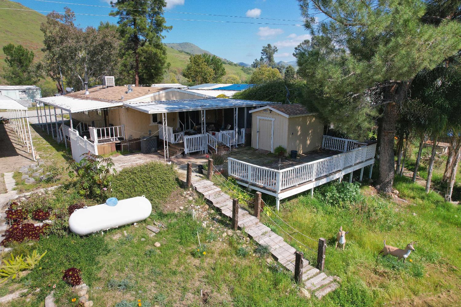 25433 East Trimmer Springs Road, Unit 4 Sanger, CA 93657 - Photo 20 of 33 a view of a house with backyard and a garden