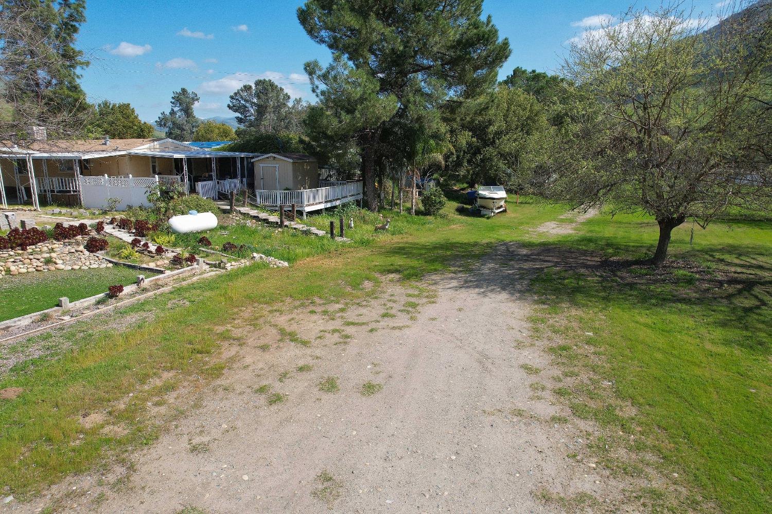 25433 East Trimmer Springs Road, Unit 4 Sanger, CA 93657 - Photo 21 of 33 a view of a house with backyard and sitting area