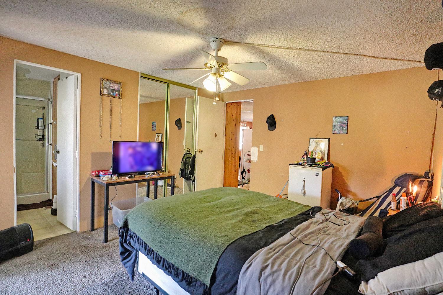 25433 East Trimmer Springs Road, Unit 4 Sanger, CA 93657 - Photo 5 of 33 a bedroom with a bed and a flat screen tv