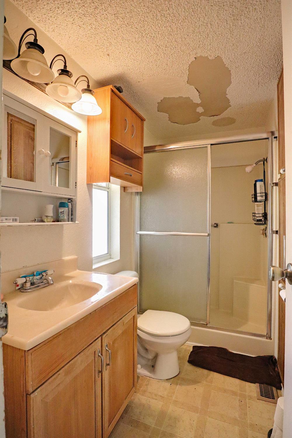 25433 East Trimmer Springs Road, Unit 4 Sanger, CA 93657 - Photo 6 of 33 a bathroom with a sink a toilet and shower