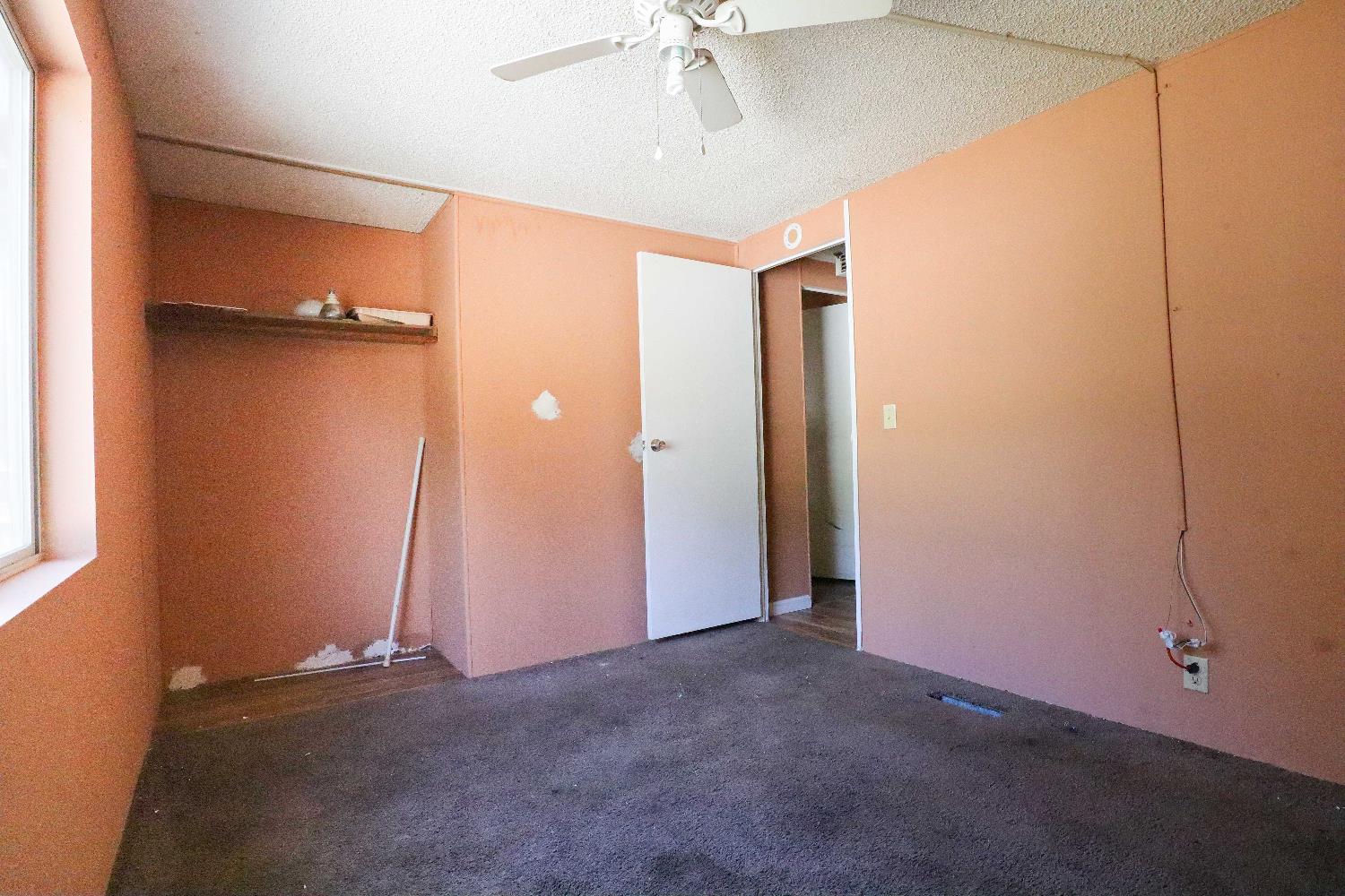 25433 East Trimmer Springs Road, Unit 4 Sanger, CA 93657 - Photo 9 of 33 an empty room with closet and a ceiling fan