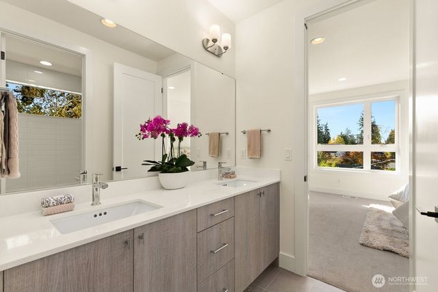 a bathroom with a sink vanity and a mirror
