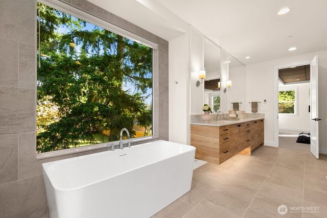 a bathroom with a bathtub sink and mirror