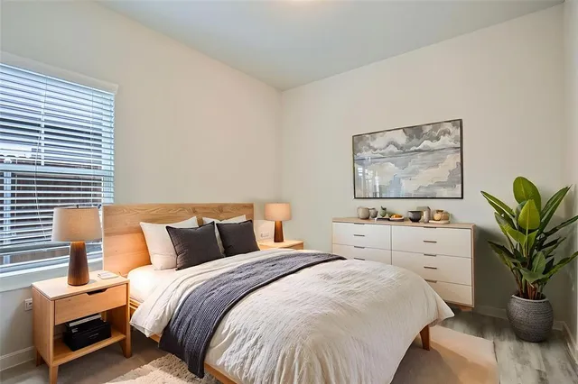 a bedroom with bed and paintings on the wall