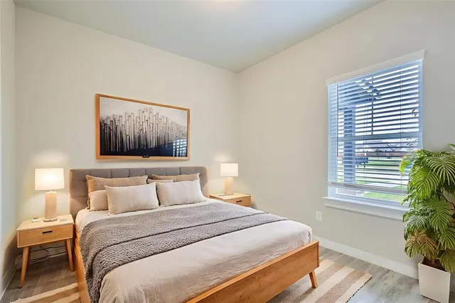 a bedroom with a bed and a painting on the wall