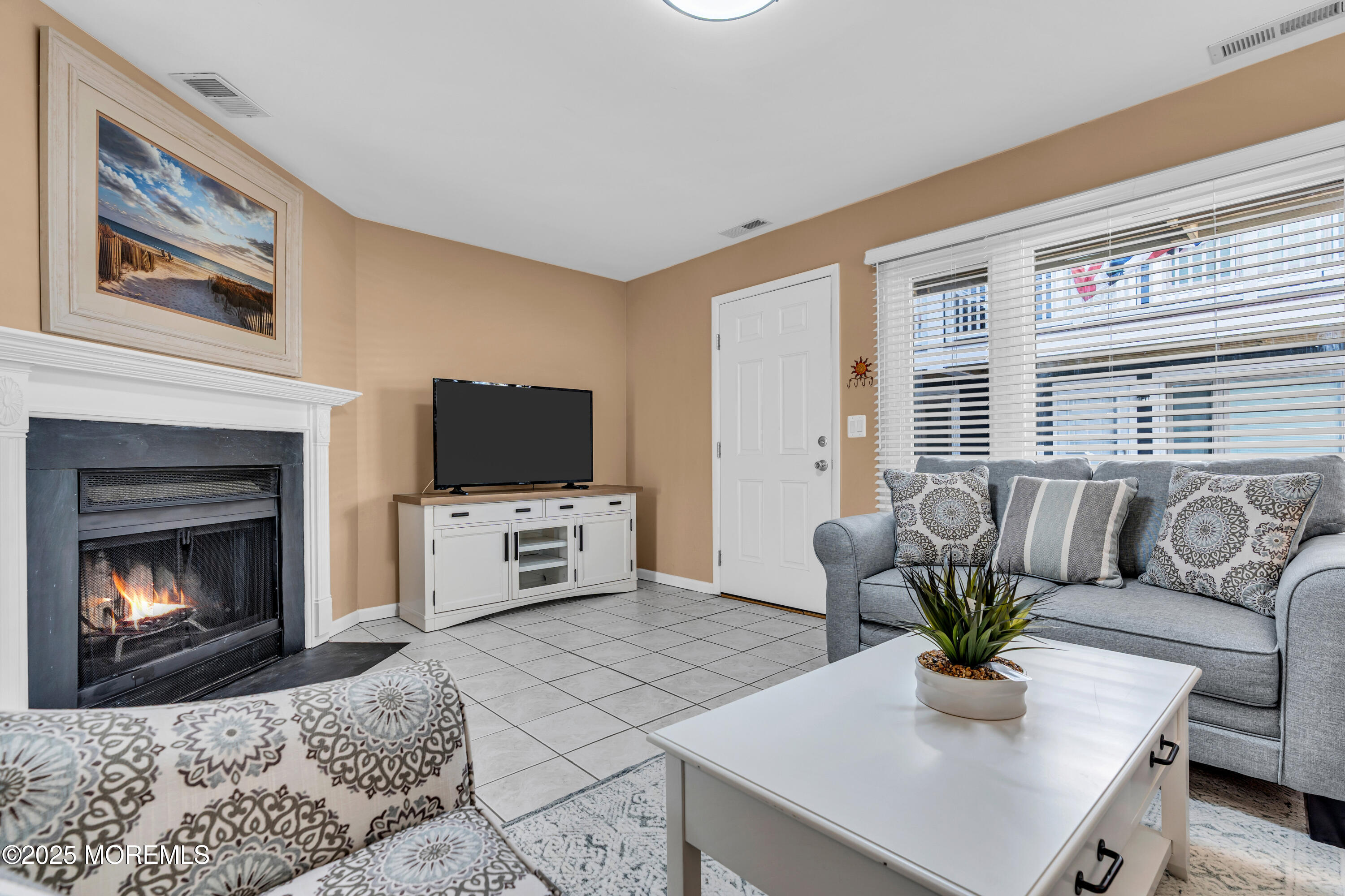 1900 Grand Central Avenue, Unit 3 Lavallette, NJ 08735 - Photo 3 of 21 a living room with furniture a flat screen tv and a fireplace