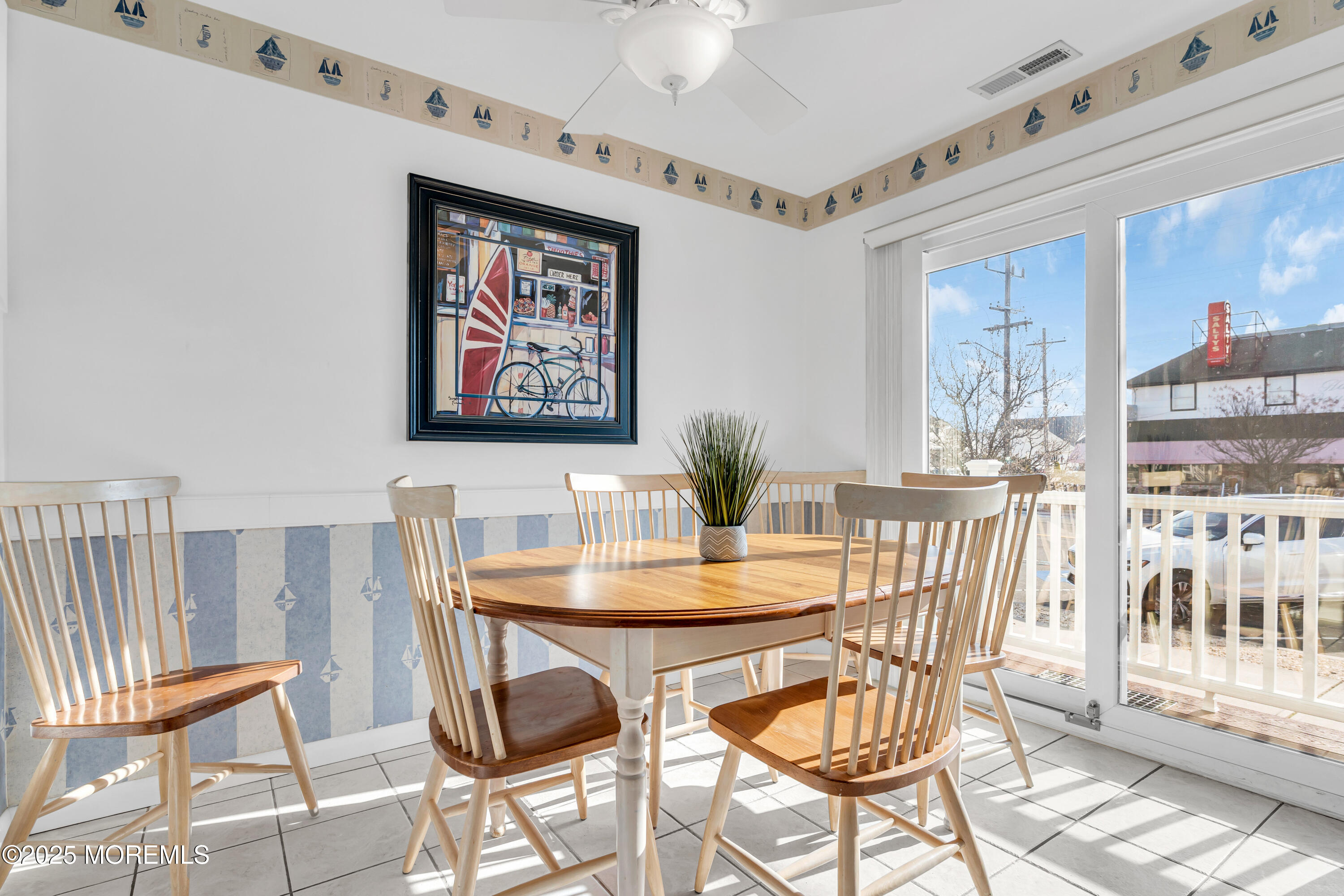 1900 Grand Central Avenue, Unit 3 Lavallette, NJ 08735 - Photo 6 of 21 a view of a dining room with furniture large window and wooden floor
