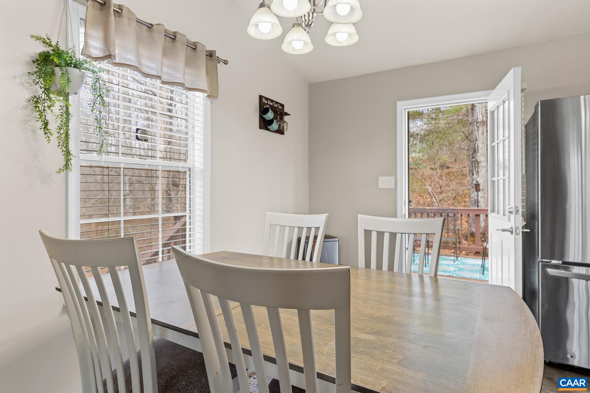 1029 West Daffodil Road Ruckersville, VA 22968 - Photo 20 of 39 a view of a dining room with furniture window and wooden floor