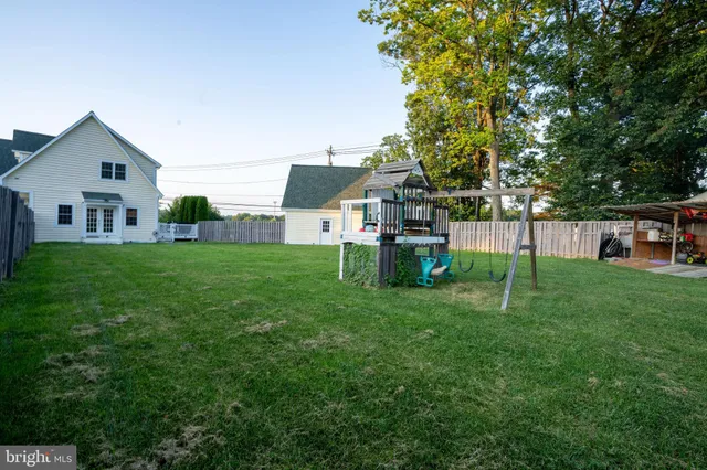 a view of a house with a yard and sitting area