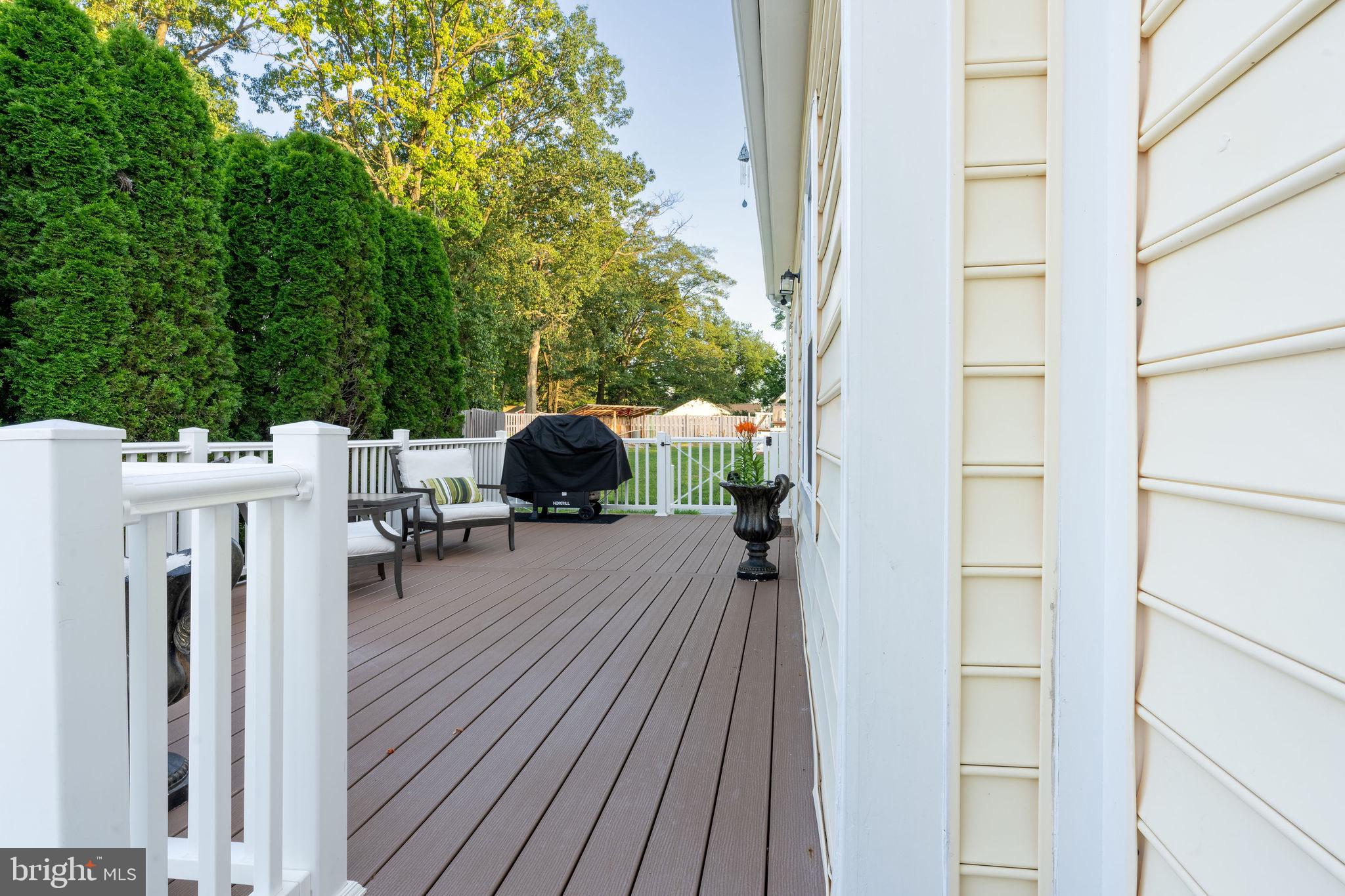 25325 Woodfield Road Damascus, MD 20872 - Photo 14 of 58 a balcony with furniture and a potted plant
