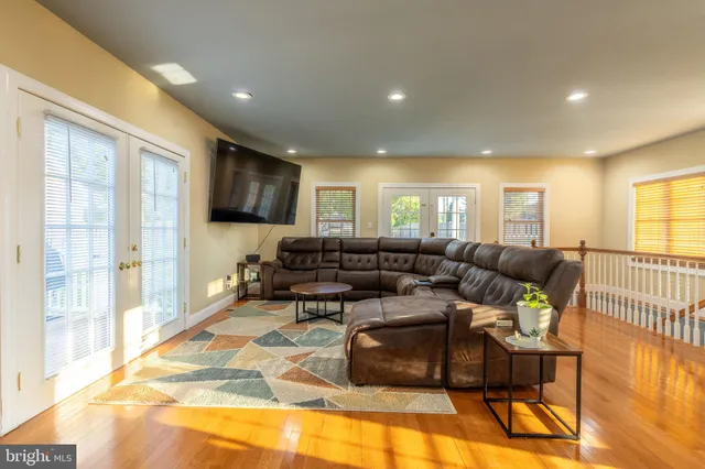 a living room with furniture and a wooden floor