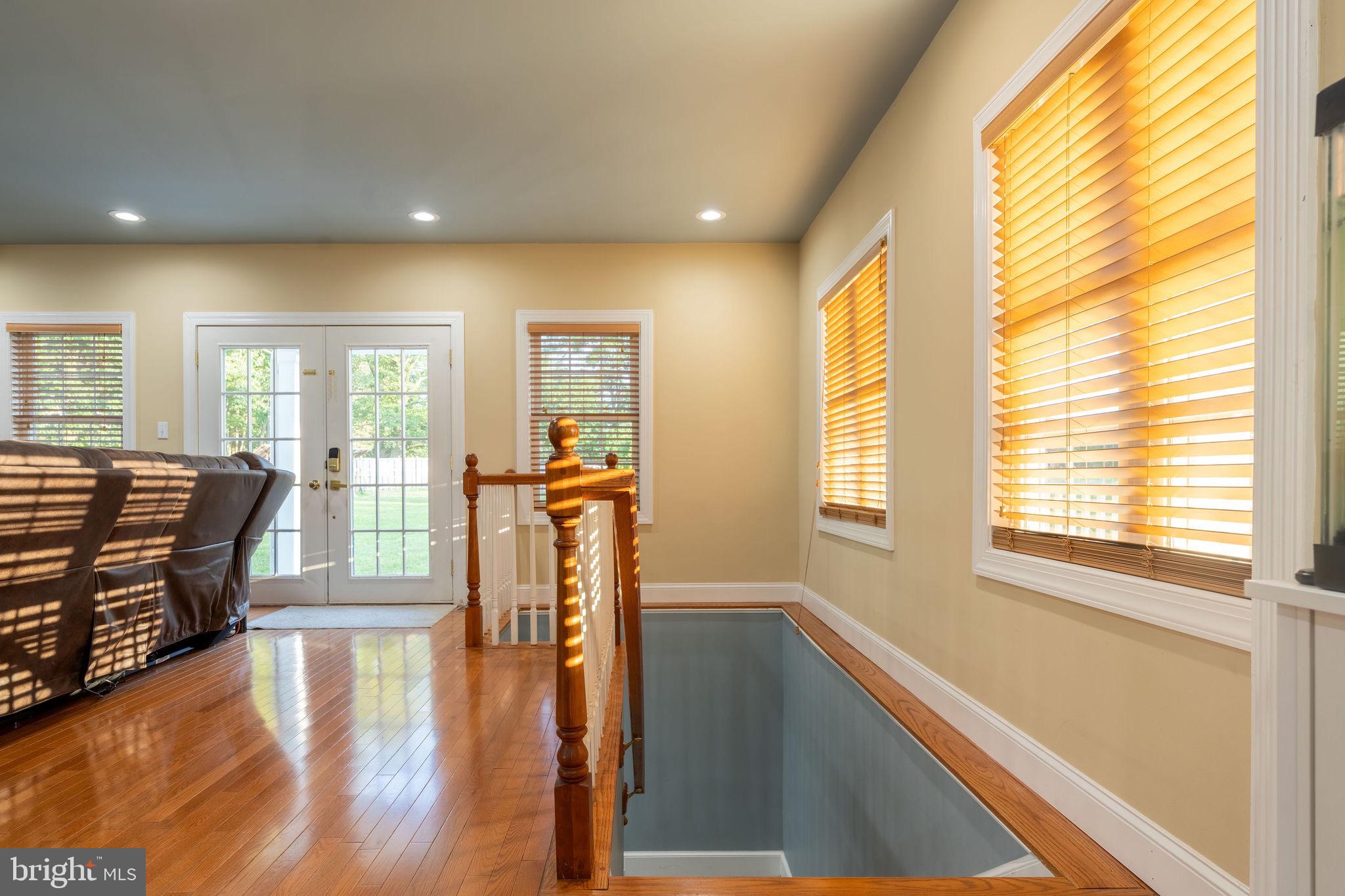 25325 Woodfield Road Damascus, MD 20872 - Photo 19 of 58 a living room with furniture and a table