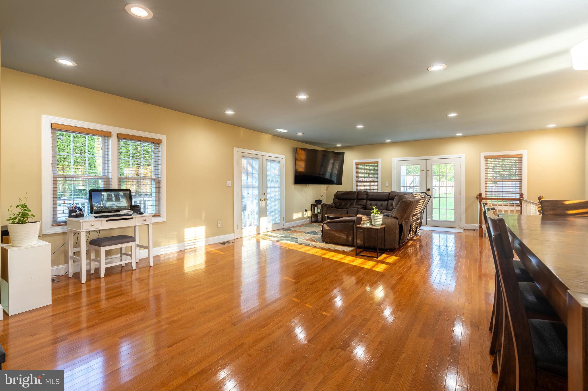 25325 Woodfield Road Damascus, MD 20872 - Photo 21 of 58 a living room with furniture and a wooden floor
