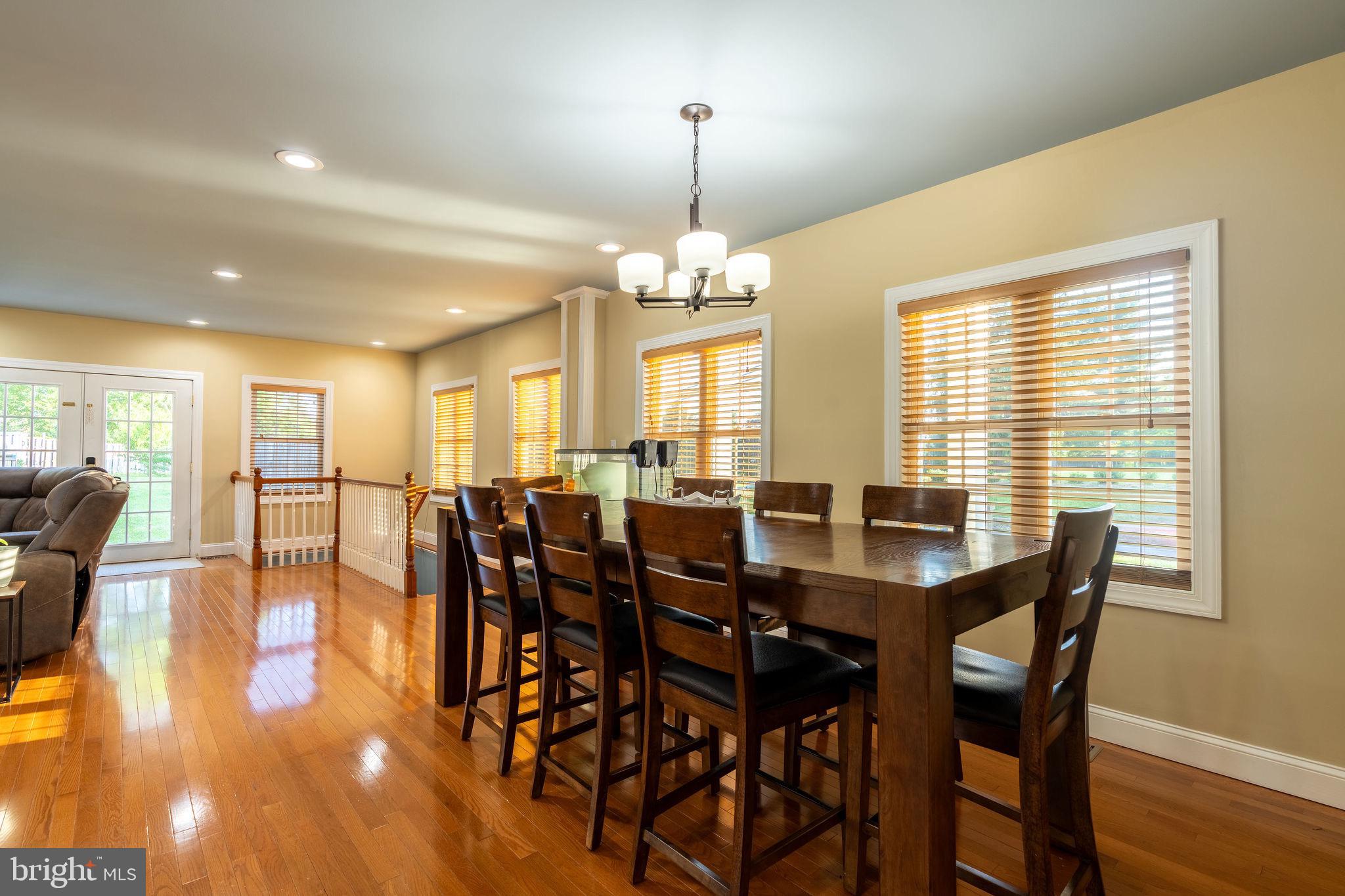 25325 Woodfield Road Damascus, MD 20872 - Photo 24 of 58 a view of a dining room with furniture window and wooden floor