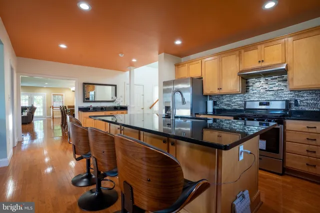 a view of a living room kitchen and a wooden floor