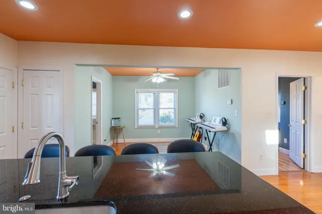 a room with lots of furniture and wooden floor